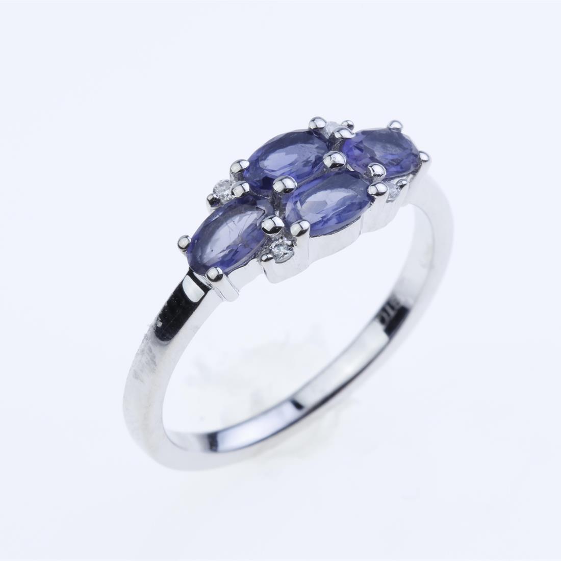 Size 7.5 Iolite & Zircon Sterling Silver Ring: Size 7.5 Iolite & Zircon Sterling Silver Ring • Metal: Sterling Silver • Stone: 5X3Mm Oval Iolite&White Zircon • Width : 6.3 Mm • Appx Weight: 2.38 Grams • Finish: Rhodiu
