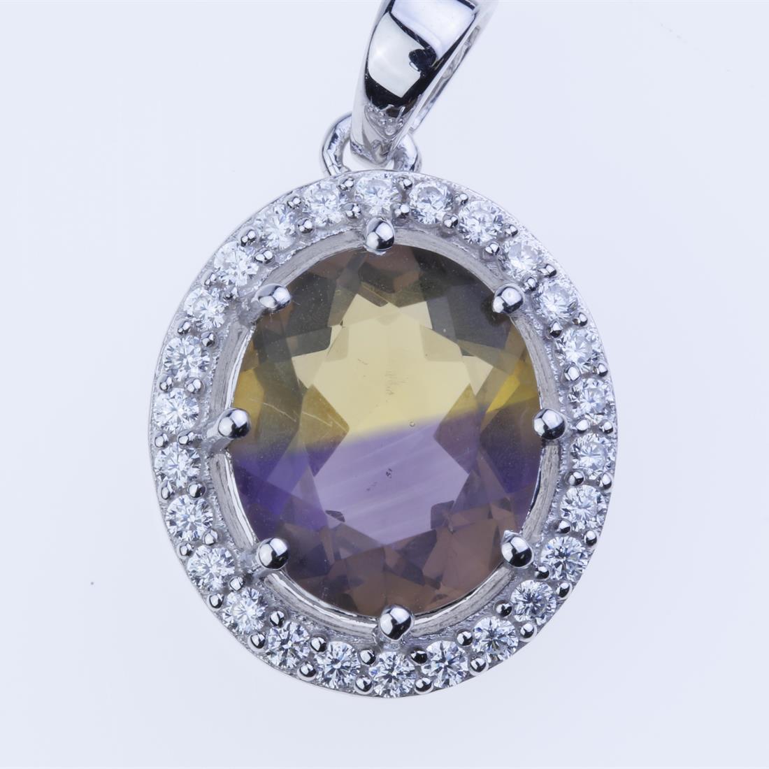 Ametrine & Zircon Silver Halo Pendant: Ametrine & Zircon Silver Halo Pendant • Metal: Sterling Silver • Stone: 12X10 Mm Oval Ametrine, Zircon • Dimension : 24.6X14.9 Mm • Total Weight: 3.3 Grams • Finish: Rhod