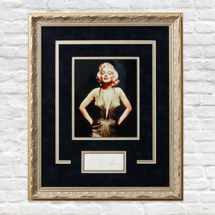 Marilyn Monroe Signed Framed Photograph: We are honored to present a rare and exquisite piece of Hollywood history: a signed photograph of the legendary Marilyn Monroe. This iconic image captures Monroe in her prime, showcasing her timeless