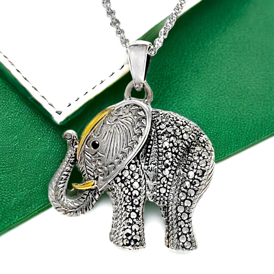 14K and Sterling Silver Marcasite Elephant Pendant: Adorned with intricate marcasite detailing and delicate 14kt gold accents, this sterling silver pendant features a charming elephant design. The 18-inch chain adds grace to this elegant piece, combini