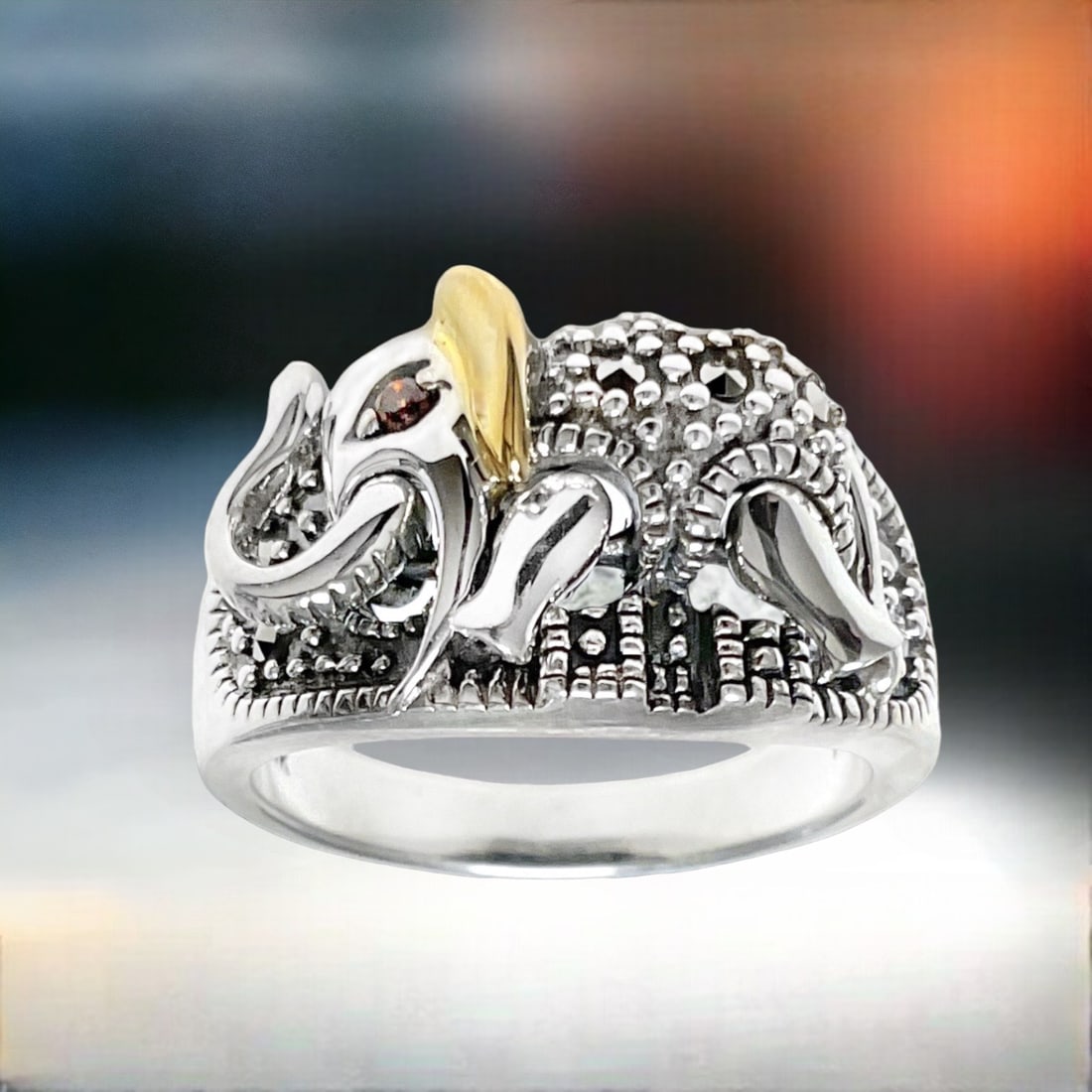 Sterling Silver & 14K Marcasite Elephant Ring: Immerse yourself in the enchanting world of this Sterling Silver and 14K Gold Marcasite Elephant Ring, adorned with a captivating garnet eye. The intricate details of the elephant motif, highlighted b