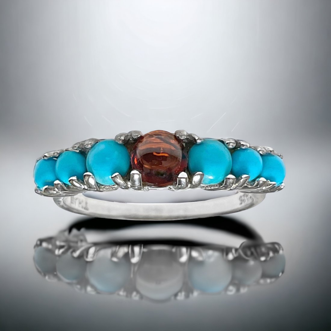 Sterling Silver Turquoise & Garnet Ring Size 9: Embrace the vibrant beauty of our Sterling Silver Turquoise & Garnet Ring in Size 9. This captivating ring features a turquoise gemstone complemented by deep red garnets, all set in sterling silver. T