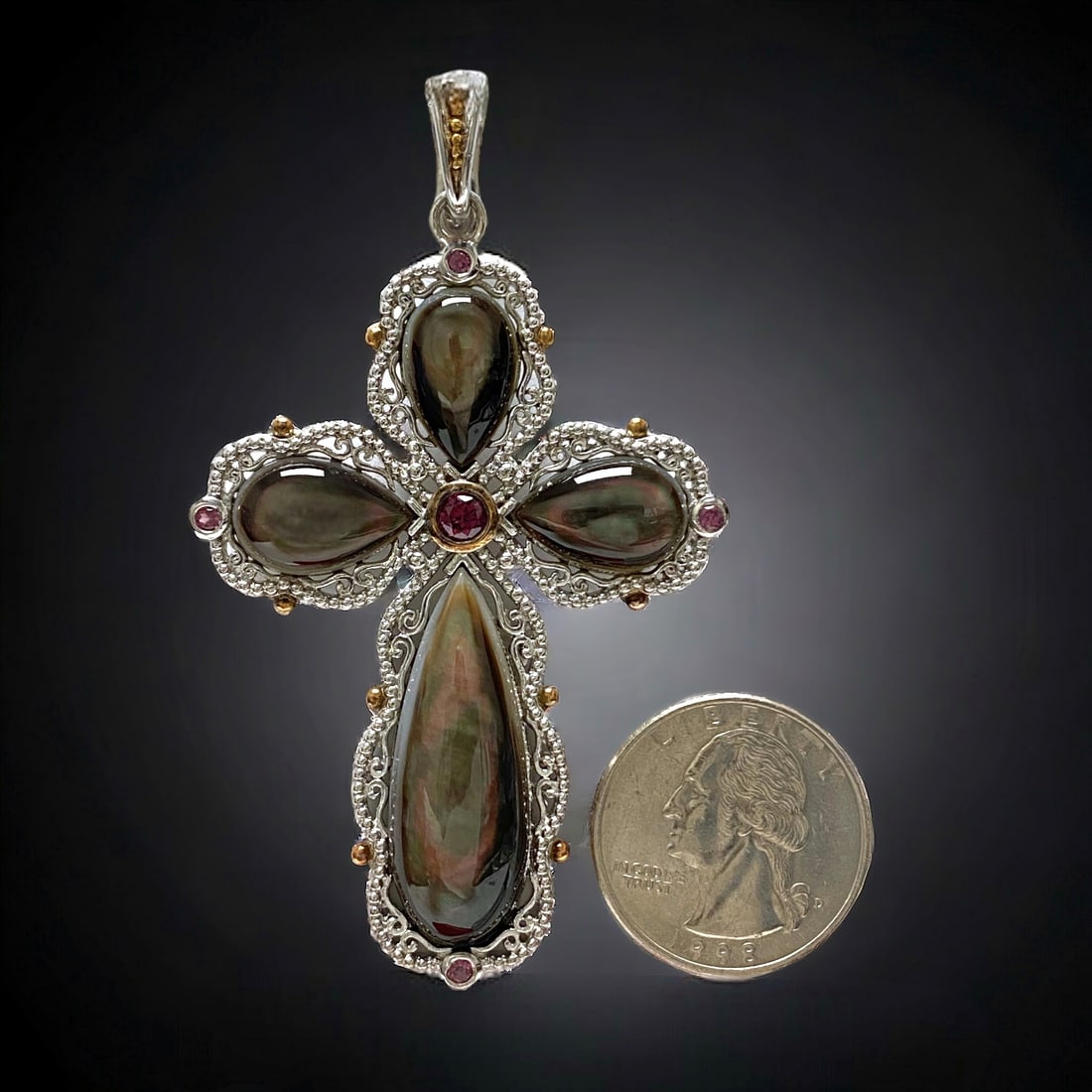 Rare Black Mother-of-Pearl & Rhodolite Garnet Ornate Cross Pendant: This Rare Black Mother-of-Pearl & Rhodolite Garnet Sterling Silver Cross Pendant is a masterpiece of elegance and sophistication. The deep black mother-of-pearl contrasts beautifully with the rich red