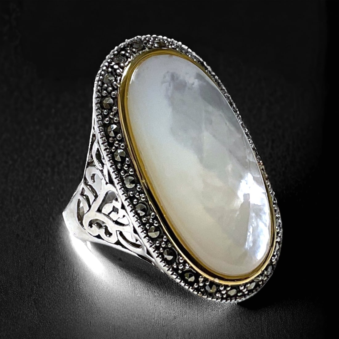 14K & Sterling Silver White Mother-of-Pearl & Marcasite Ring in Size 9: Product Details Item: Ring Metal: 14K Gold & Sterling Silver Gemstone: White Mother-of-Pearl & Marcasite Approximate Measurements: Width: 33.9 mm Ring Size: Size 9 Chain Length: Not Applicable<