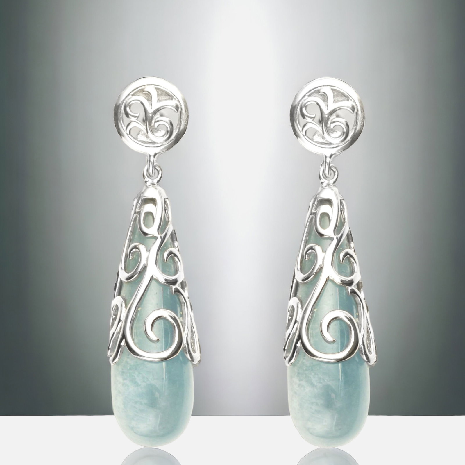 Filagree Sterling Silver Drop Earrings eloquently wrapped around Amazonite: Product Details Item: Earrings Metal: Sterling Silver Gemstone: Amazonite Approximate Measurements: 54.3 mm X 11.6 mm Ring Size: Not Applicable Chain Length: Not Applicable Chain Metal: