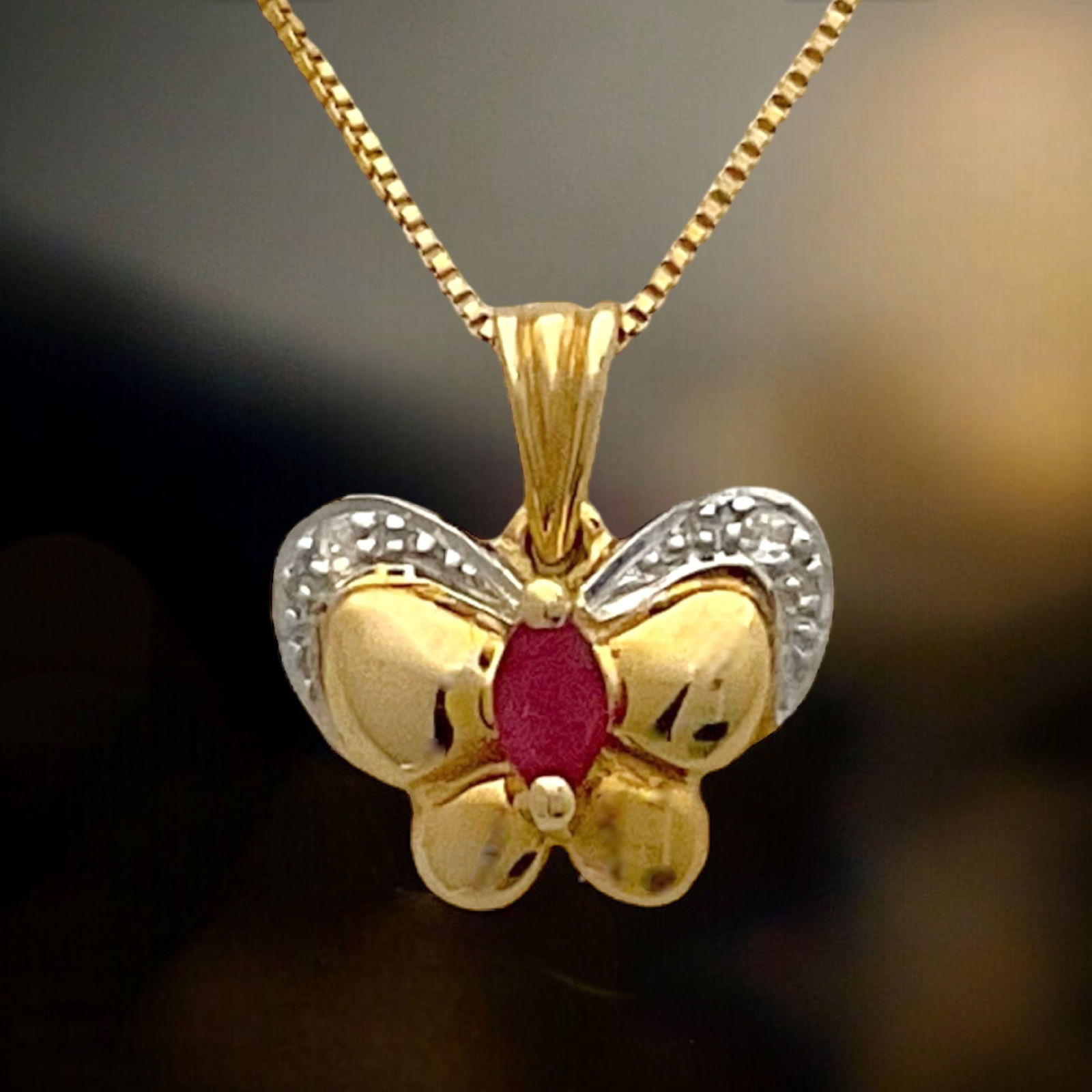 10K Gold Ruby Butterfly Pendant with 18" chain: Product Details Item: Pendant Metal: 10K Gold Gemstone: Ruby Approximate Measurements: 12.3 mm X 11.4 mm Ring Size: Not Applicable Chain Length: 18" Chain Metal: 10K Gold