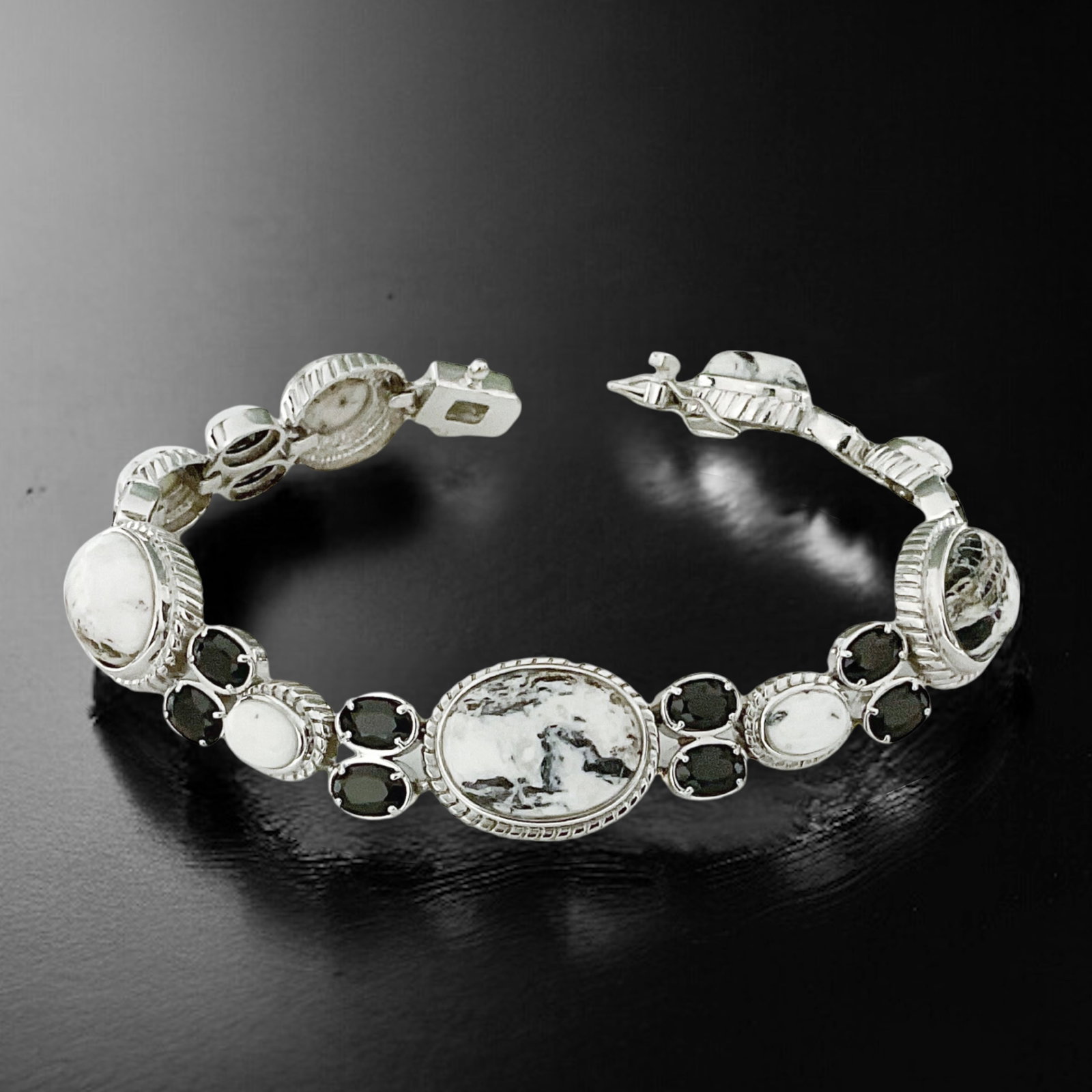 White Buffalo & Black Spinel Sterling Silver 7.5 inch Bracelet: Product Details Item: Bracelet Metal: Sterling Silver Gemstone: White Buffalo , Black Spinel White buffalo: Various Sizes- 16mm X 12mm, 14mm X 10mm, 1mm X 9mm , 7mm X 5mm Black Spinel: (16) 6mm X 4m