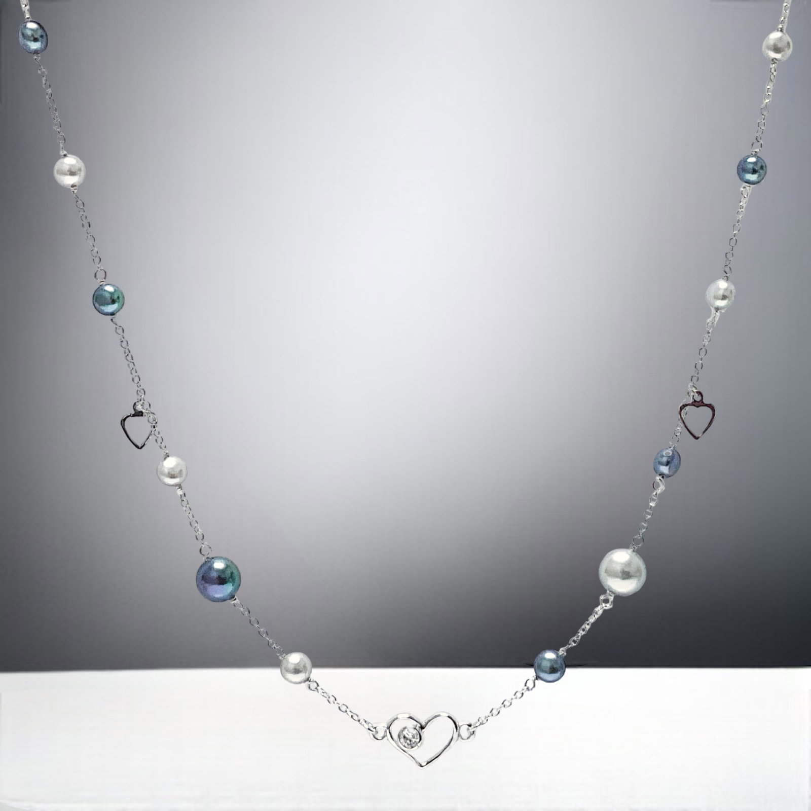Multi-Color Station Pearl Sterling Silver Necklace: Product Details Item: Necklace Metal: Sterling Silver Gemstone: Peacock Pearls, Light Grey Pearl, & White CZ Approximate Measurements: 18" Length Ring Size: Not Applicable Chain Length: Not