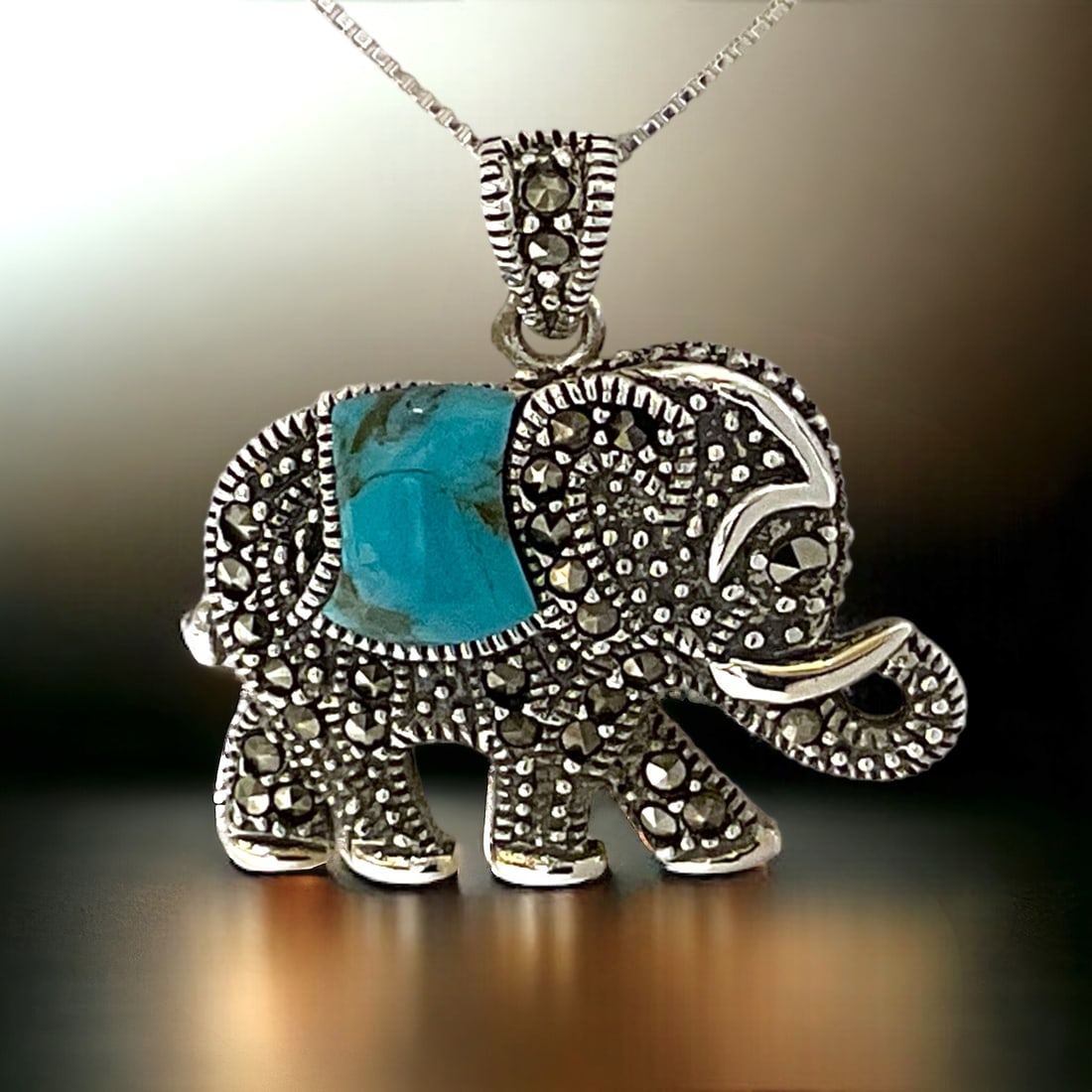 Noble Turquoise & Marcasite Elephant Sterling Silver Pendant: Product Details Item: Pendant Metal: Sterling Silver Gemstone: Turquoise & Marcasite Approximate Measurements: 27 mm X 26.7 mm Ring Size: Not Applicable Chain Length: 18" Chain Metal: St