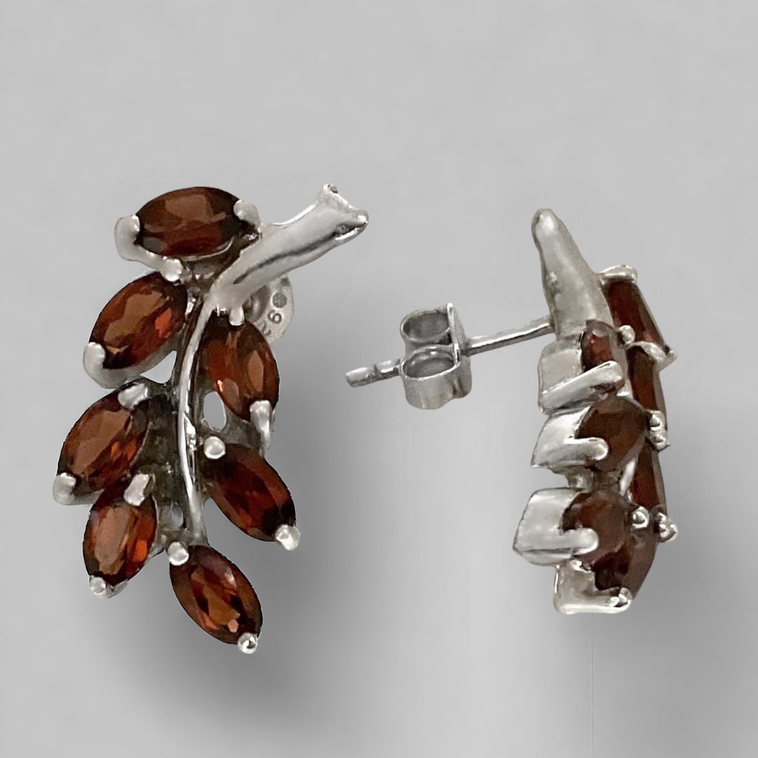 Dazzling Marquise Garnet Earrings in a Sterling Silver Leaf Design: Product Details Item: Earrings Metal: Sterling Silver Gemstone: Garnet Approximate Measurements: 20.8 mm X 10.6 mm Ring Size: Not Applicable Chain Length: Not Applicable Chain Metal: