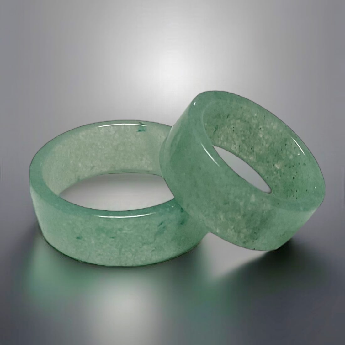 Set of 2 Harmonious Green Jade Band Set Size 6 & Size 10: Product Details Item: Ring Metal: Not Applicable Gemstone: Green Jade Approximate Measurements: Width: 8 mm Ring Size: 6 & 10 Chain Length: Not Applicable Chain Metal: Not Applicable<