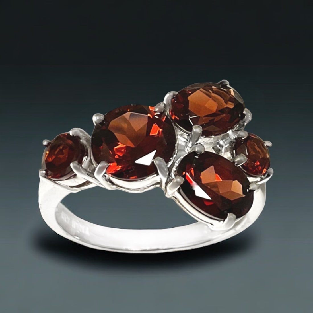 Stellar 5-Stone Garnet Gemstone Ring crafted in Sterling Silver - Size 7.25: Product Details Item: Ring Metal: Sterling Silver Gemstone: Garnet Approximate Measurements: Width: 13.8 mm Ring Size: 7.25 Chain Length: Not Applicable Chain Metal: Not Applicable