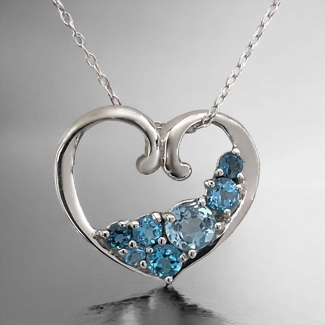 Spectacular array of Blue Topaz Gems set in a Sterling Silver Heart with an 18" chain (1 of 1)