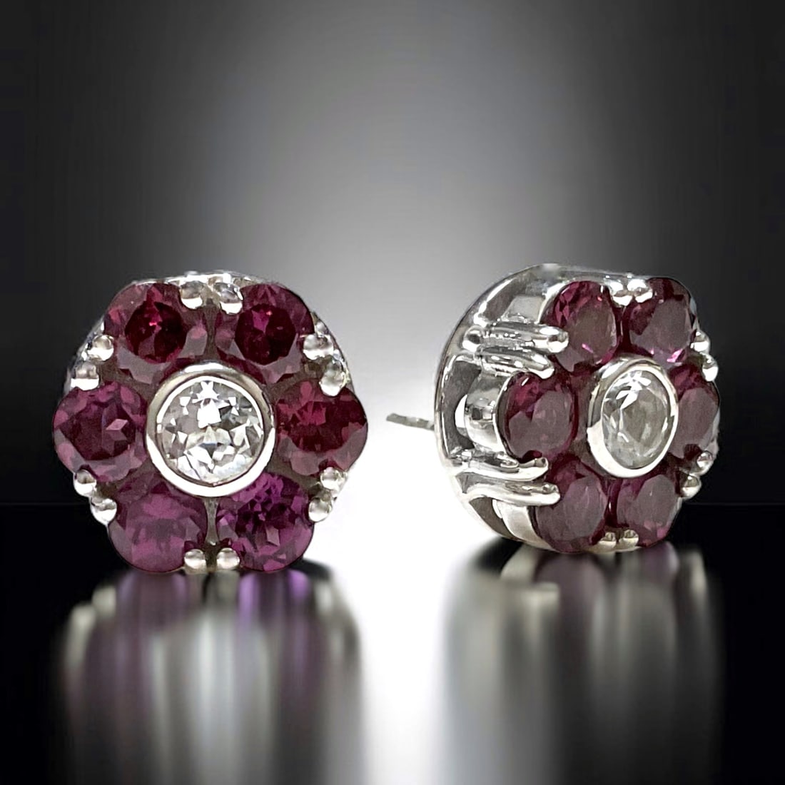 Luxurious Deep Garnet Flower Earrings with White Topaz and set in Sterling Silver: Product Details Item: Earrings Metal: Sterling Silver Gemstone: Garnet & White Topaz Approximate Measurements: Width: 12 mm Ring Size: Not Applicable Chain Length: Not Applicable Chain M