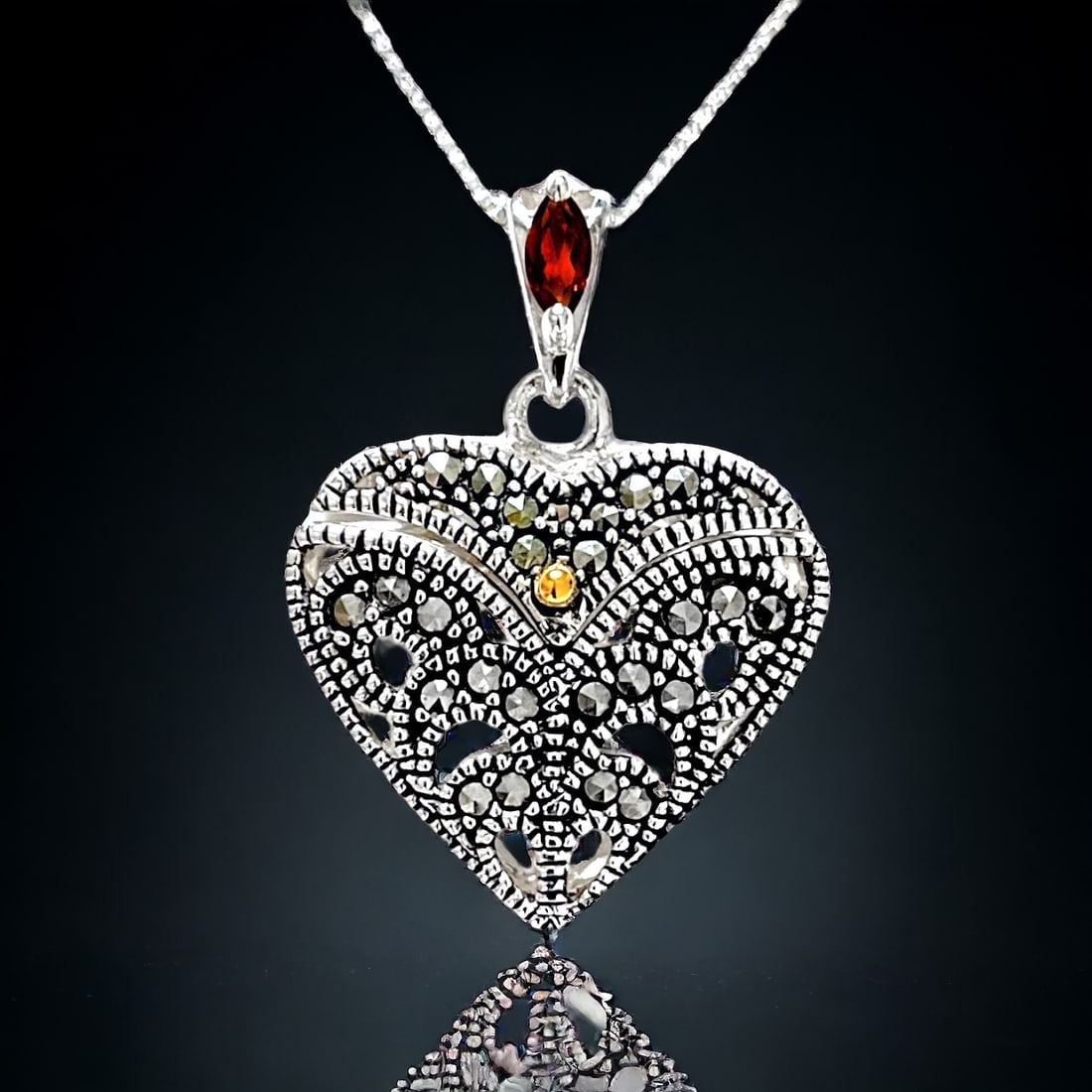 14K & Sterling Silver Marcasite Heart Locket Pendant: Product Details Item: Locket Metal: 14K Gold & Sterling Silver Gemstone: Garnet & Marcasite Approximate Measurements: 27.3 mm X 19.5 mm Ring Size: Not Applicable Chain Length: 18" Chain