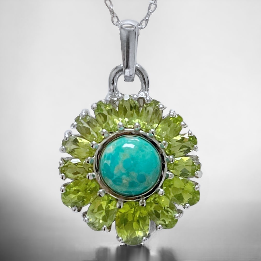 Turquoise & Peridot Sundial Pendant set in Sterling Silver with 18" chain: Product Details Item: Pendant Metal: Sterling Silver Gemstone: Turquoise & Peridot Approximate Measurements: Length: 33.9 mm and Width: 22.3 mm Ring Size: Not Applicable Chain Length: 18" <