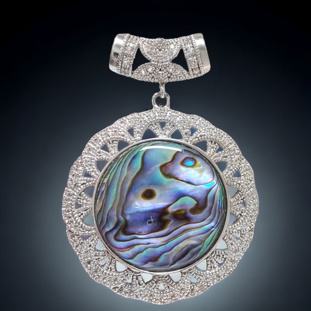 Bali style Abalone Sterling Silver Pendant with 1.48 ctw White Topaz accents: 1.48ct white topaz Product Details Item: Pendant Metal: Sterling Silver Gemstone: Abalone & White Topaz Approximate Measurements: 59.2 mm X 43.2 mm Ring Size: Not Applicable Chain Length: Not A