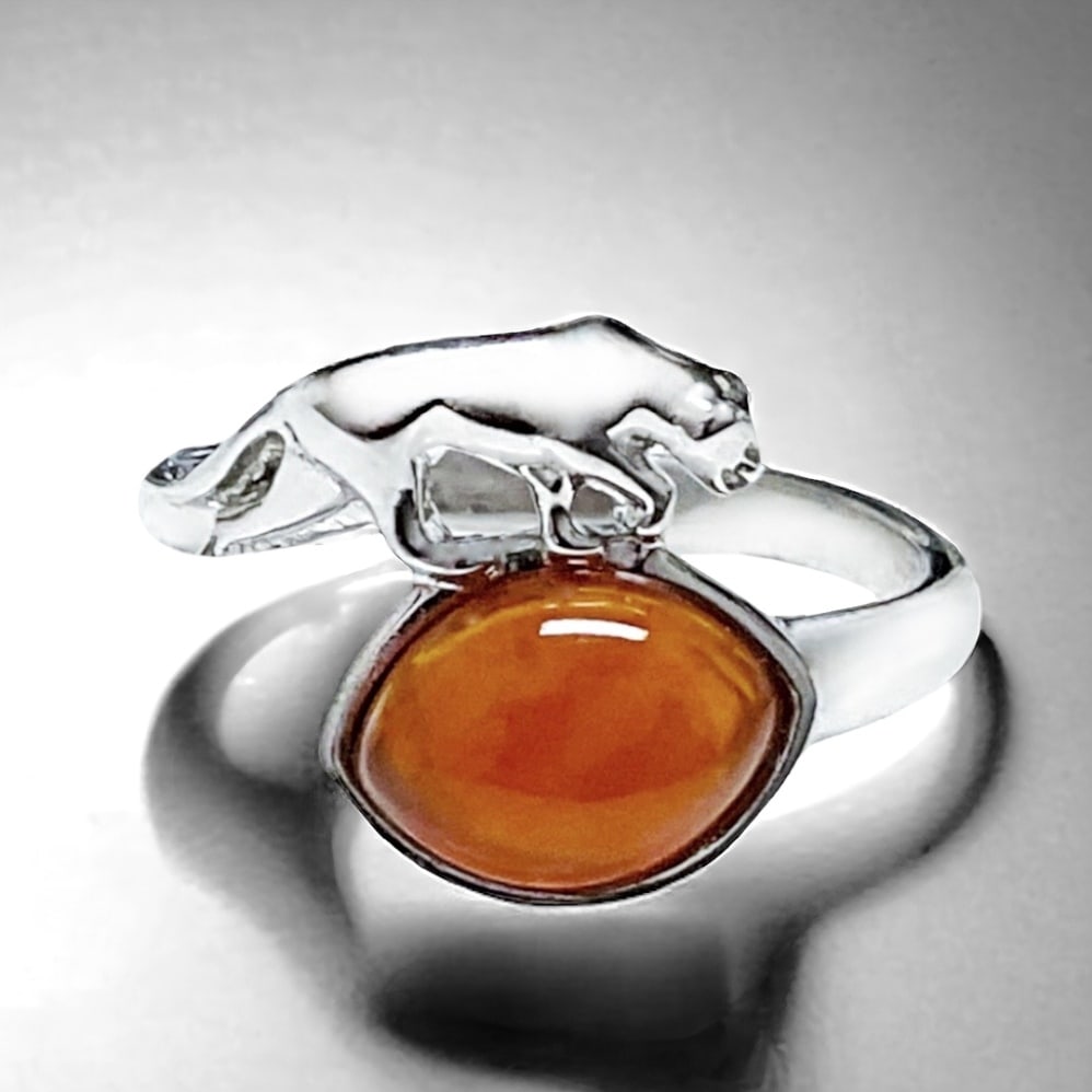 Exotic Canelian Ring adorned with a Panther crafted in Sterling Silver - Size 7: Product Details Item: Ring Metal: Sterling Silver Gemstone: Canelian Approximate Measurements: Width: 13.6 mm Ring Size: 7 Chain Length: Not Applicable Chain Metal: Not Applicable