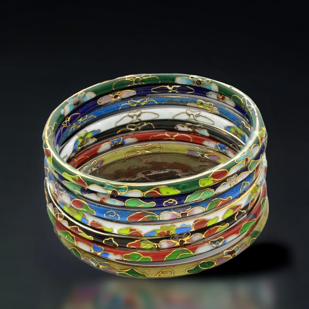 Set of 7 Cloisonne Bracelets that are each elaborated decorated to provide an array of color to your: Product Details Item: Bangle Bracelet Metal: Not Applicable Gemstone: Cloisonne Approximate Measurements: Each Piece is 4 mm wide Ring Size: Not Applicable Chain Length: Not Applicable