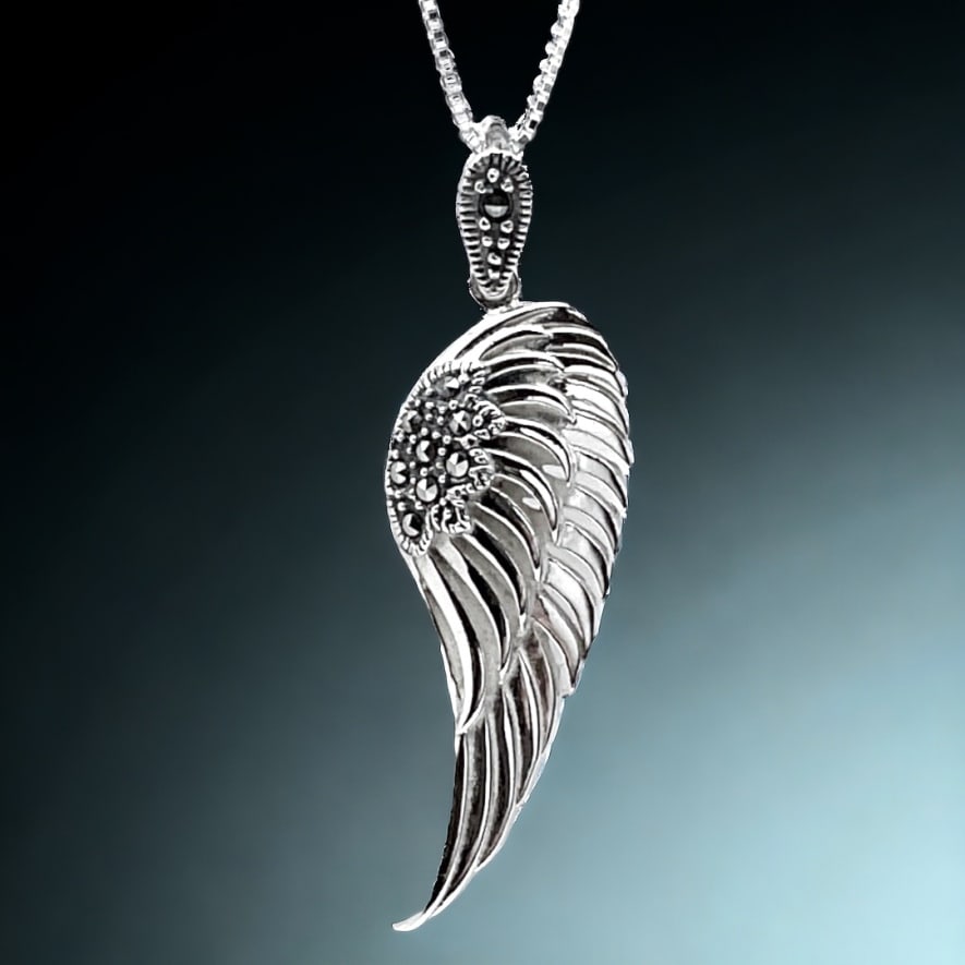 Sterling Silver Marcasite Angel Wing Pendant with 18" Chain: Product Details Item: Pendant Metal: Sterling Silver Gemstone: Marcasite Approximate Measurements: 42.7 mm X 13.1 mm Ring Size: Not Applicable Chain Length: 18" Chain Metal: Sterling