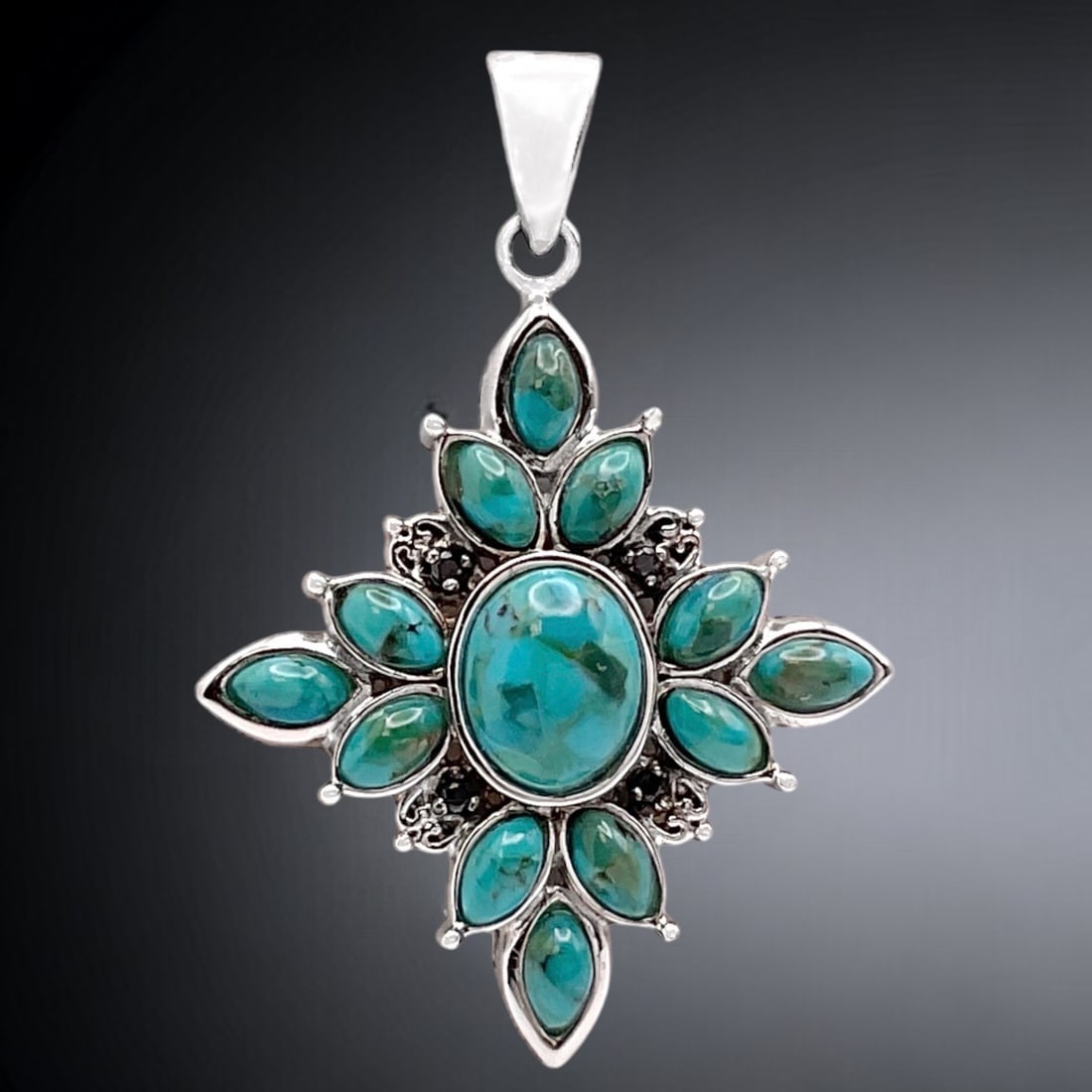 Breathtaking Turquoise Starburst Pendant with Black Spinel and set in Sterling Silver: Product Details Item: Pendant Metal: Sterling Silver Gemstone: Turquoise & Black Spinel Approximate Measurements: 46.3 mm X 31.8 mm Ring Size: Not Applicable Chain Length: Not Applicable