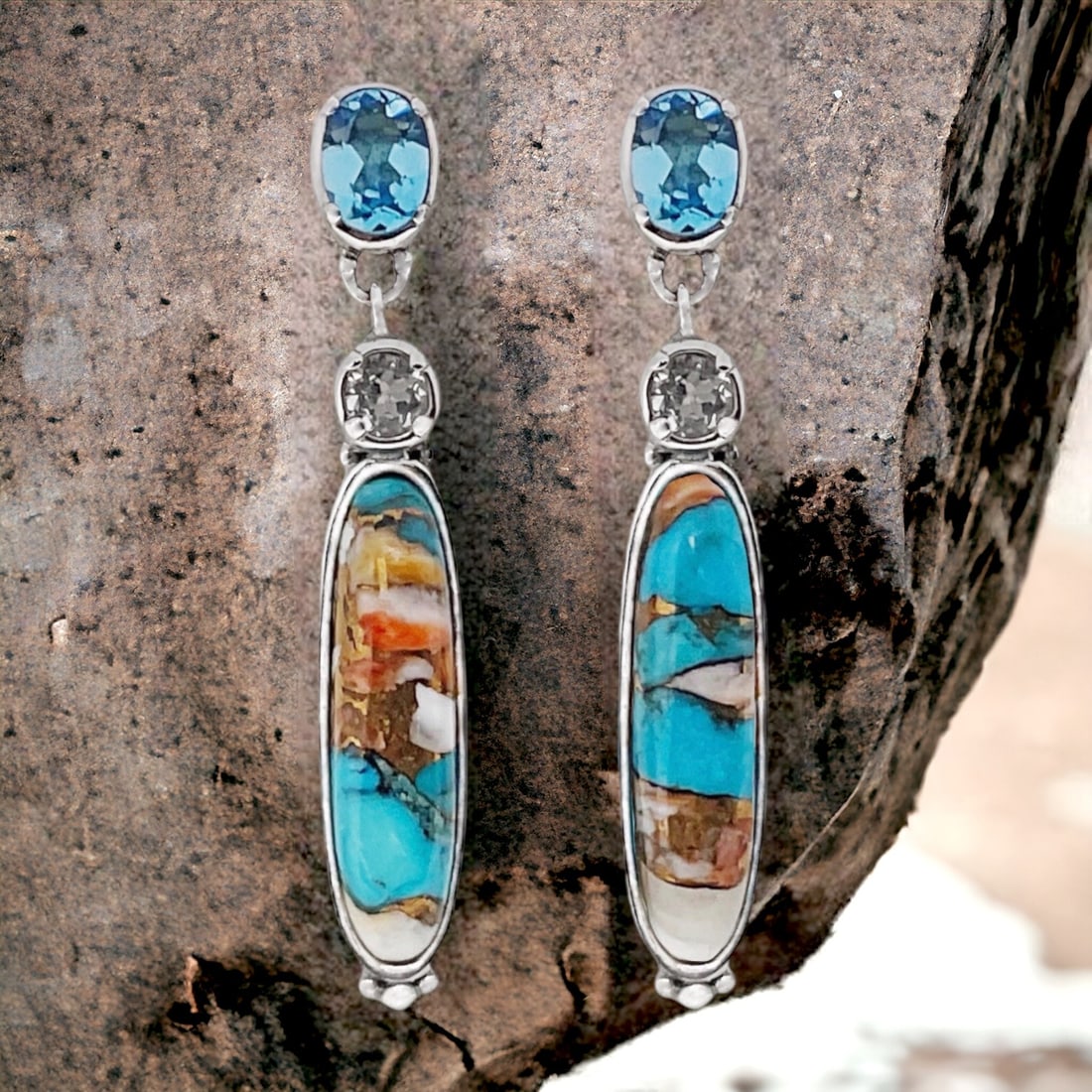 Spiney Turquoise Earrings with White Topaz and Swiss Blue Topaz crafted in Sterling Silver: Product Details Item: Earrings Metal: Sterling Silver Gemstone: Spiney Turquoise, White Topaz, & Swiss Blue Topaz Approximate Measurements: 46.6 mm X 7.9 mm Ring Size: Not Applicable Chain Len