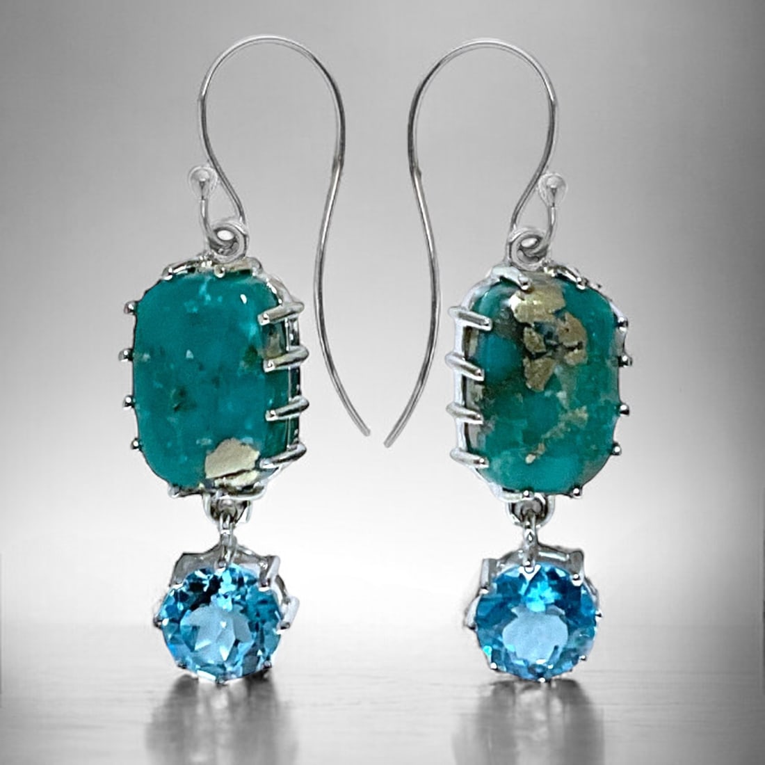 Prestigious Campo Frio Turquoise & Swiss Blue Topaz Earrings set in Sterling Silver: Campo Frio Turquoise Stabilized Turquoise: Two rectangular 14 mm X 10 mm cabochons Swiss Blue Topaz: Two round 8 mm modified-brilliant cut Product Details Item: Earrings Metal: Sterling Silver Gemston