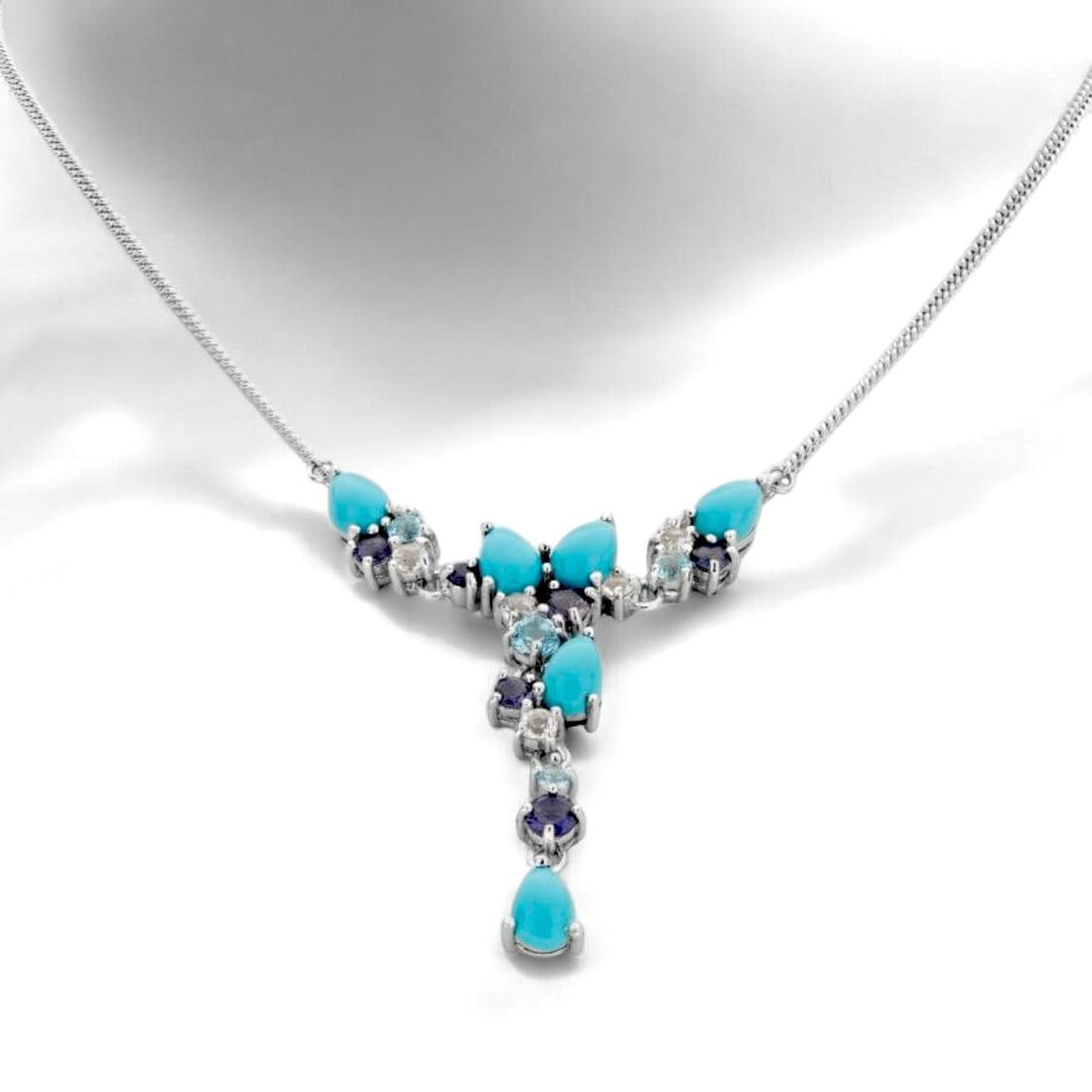Alluring "Y" Necklace with Turquoise, Iolite, Swiss Blue Topaz, & White Topaz crafted in Sterling: Product Details Item: Necklace Metal: Sterling Silver Gemstone: Sonora Turquoise, Iolite, Swiss Blue Topaz, & White Topaz Approximate Measurements: Width: 41.4 mm Ring Size: Not Applicable Chai
