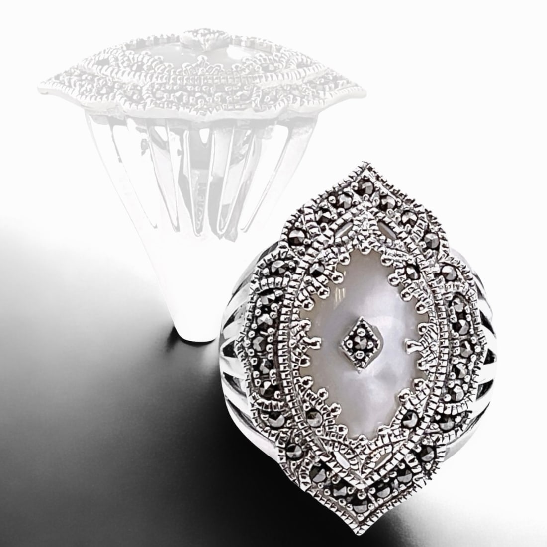 Majestic White Mother-of-Pearl Sterling Silver Ring accented with sparkling Marcasite: Product Details Item: Ring Metal: Sterling Silver Gemstone: White Mother-of-Pearl & Marcasite Approximate Measurements: Width: 29.9 mm Ring Size: 10 Chain Length: Not Applicable Chain