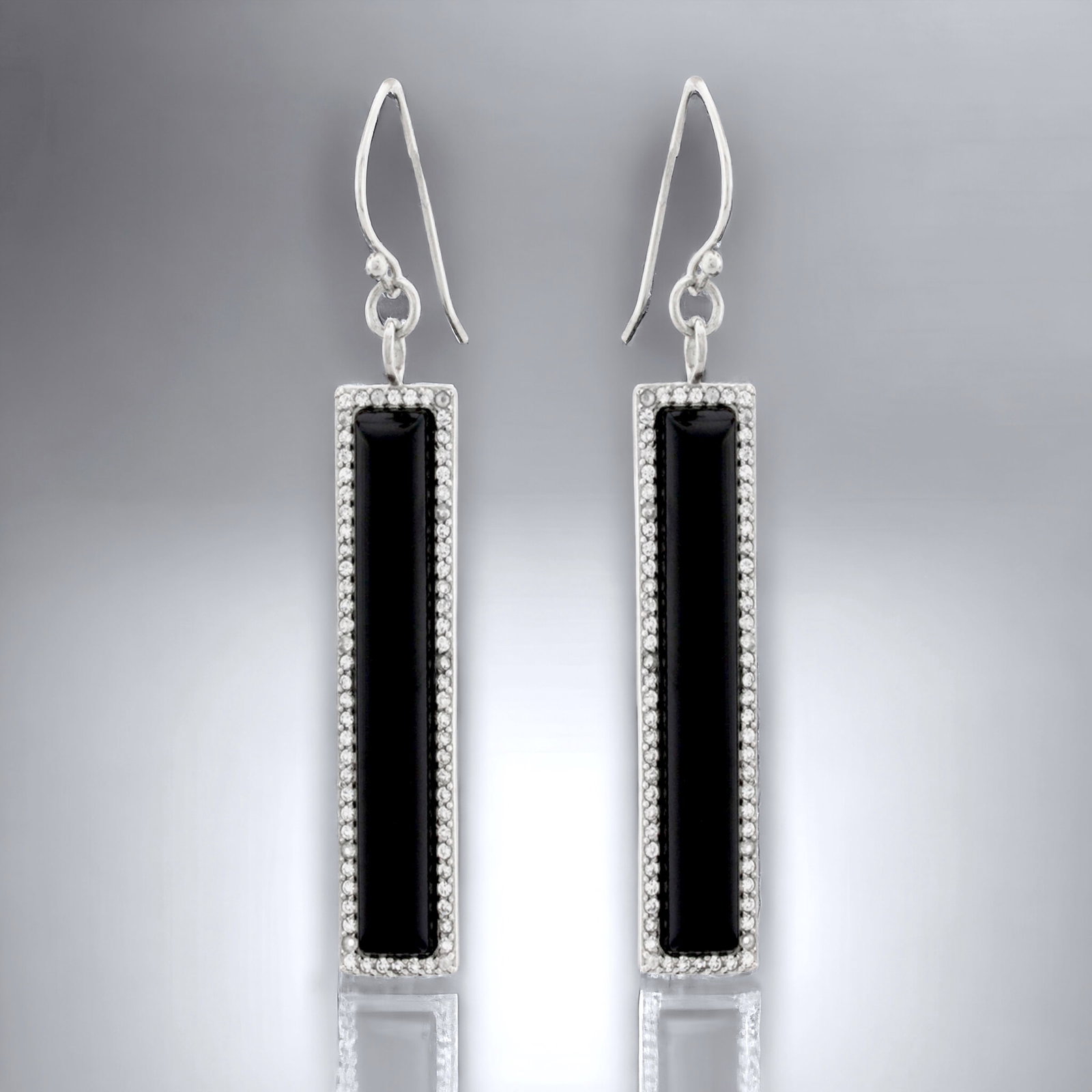 Elongated Rectangle Black Agate adorned with dazzaling White Topaz Earrings: Black Agate: 2 Gemstones each: 42 mm X 7 mm White Topaz: (144) 1 mm round Product Details Item: Earrings Metal: Sterling Silver Gemstone: Black Agate & White Topaz Approximate Measurements: 65.5 mm X 