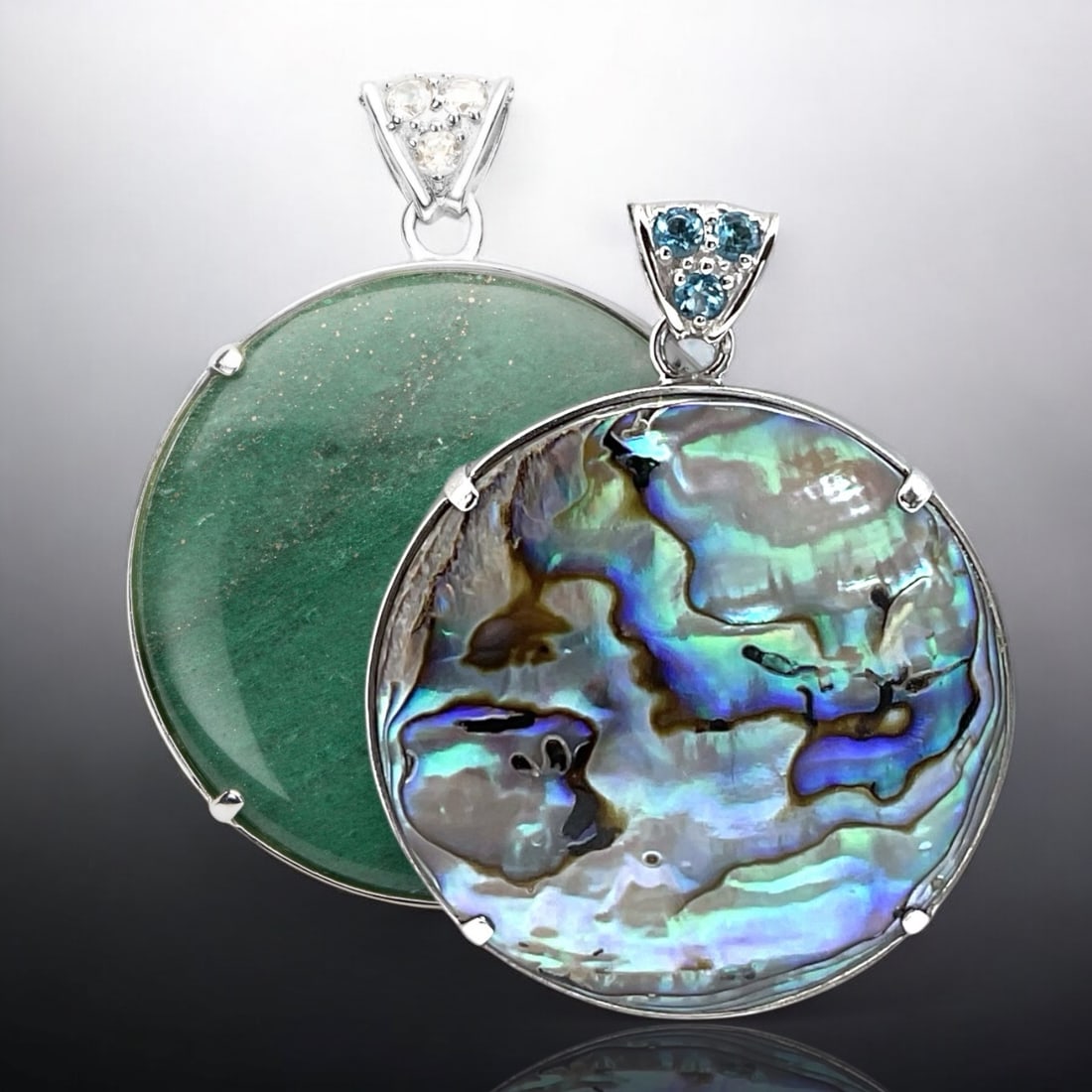 Reversible Sterling Silver Pendant with Green Adventurine on one side and Abalone on the other: 40 mm Round Centerstones: Abalone & Green Adventurine Product Details Item: Pendant Metal: Sterling Silver Gemstone: Adventurine, Abalone Swiss Blue Topaz, &White Topaz Approximate Measurements: 53.5