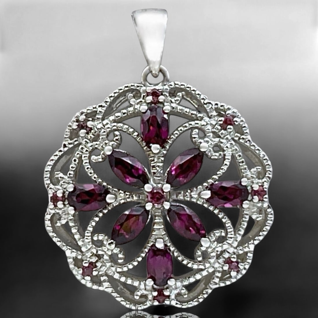 Exquisite Ornate Rhodolite Garnet Filigree Pendant in Lustrous Sterling Silver: Product Details Item: Pendant Metal: Sterling Silver Gemstone: Rhodolite Garnet Approximate Measurements: 35.3 mm X 27.3 mm Ring Size: Not Applicable Chain Length: Not Applicable Chain