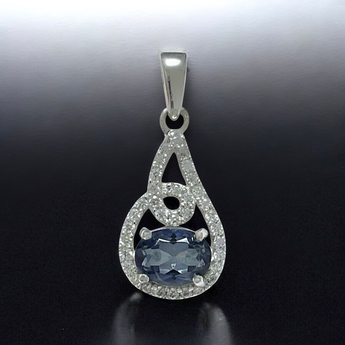 Heavenly Oval Iolite Sterling Silver Pendant Surronded by White Zircon: Product Details Item: Pendant Metal: Sterling Silver Gemstone: Iolite & White Zircon Approximate Measurements: 26.4 mm X 11.3 mm Ring Size: Not Applicable Chain Length: Not Applicable