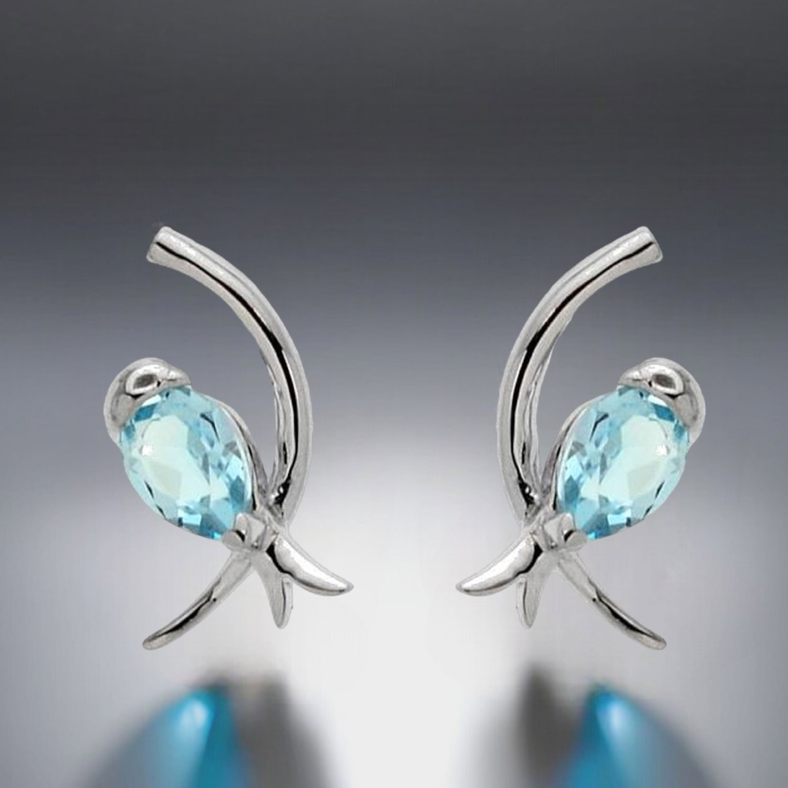 Enchanting Bird Earrings set in Sterling Silver with Sky Blue Topaz: Product Details Item: Earrings Metal: Sterling Silver Gemstone: Sky Blue Topaz Approximate Measurements: 17.2 mm X 9.4 mm Ring Size: Not Applicable Chain Length: Not Applicable Chain Met