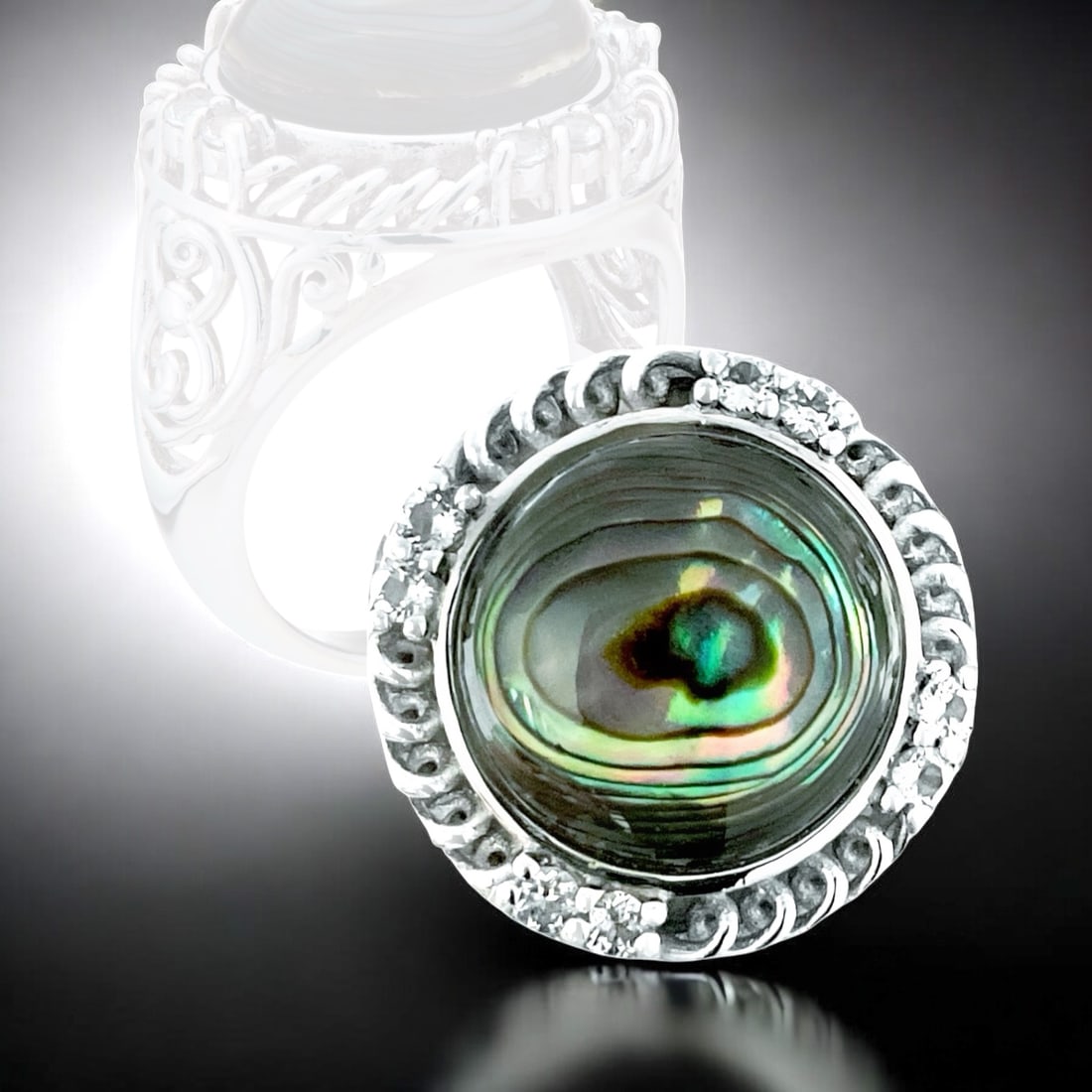 Oceaniac Abalone Sterling Silver Ring adorned with White Topaz - Size 6: Product Details Item: Ring Metal: Sterling Silver Gemstone: Abalone & White Topaz Approximate Measurements: Width: 18.7 mm Ring Size: 6 Chain Length: Not Applicable Chain Metal: Not A