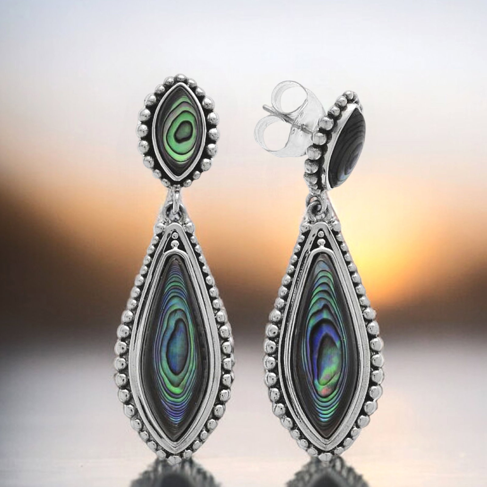 Mesmerizing Abalone Drop Earrings crafted in Sterling Silver: Product Details Item: Earrings Metal: Sterling Silver Gemstone: Abalone Shell Approximate Measurements: 53.3 mm X 16.5 mm Ring Size: Not Applicable Chain Length: Not Applicable Chain
