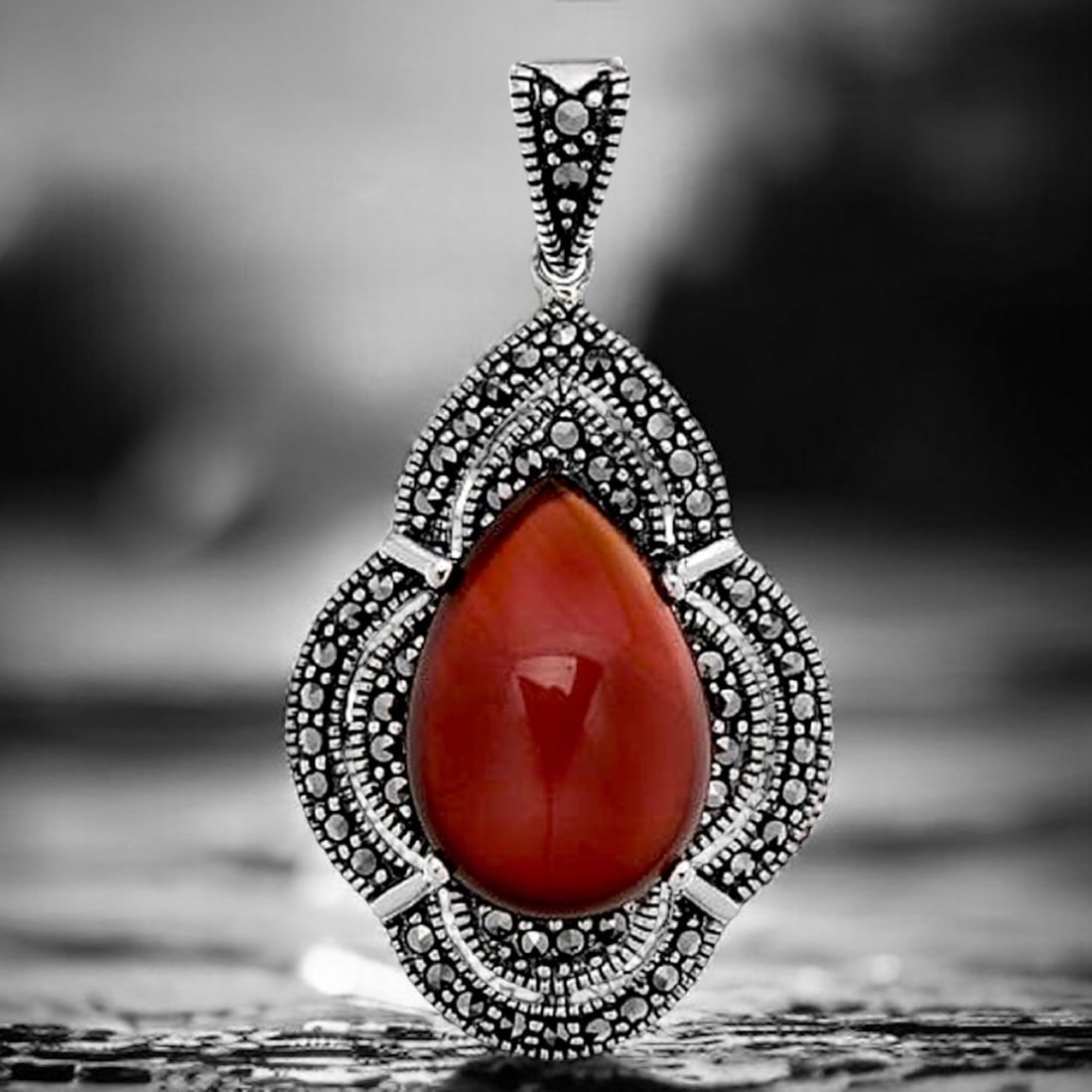Deep Red Agate Pear Shaped Sterling Silver Pendant with Dazzling Marcasite Accents: Product Details Item: Pendant Metal: Sterling Silver Gemstone: Red Agate & Marcasite Approximate Measurements: 41.5 mm X 22 mm Ring Size: Not Applicable Chain Length: Not Applicable Chai