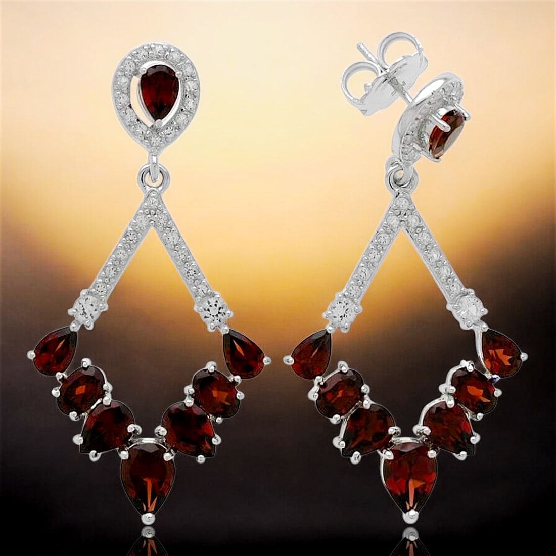 Chandlier Garnet Earrings Set in Sterling Silver with White Topaz: Product Details Item: Earrings Metal: Sterling Silver Gemstone: Garnet & White Topaz Approximate Measurements: 52.4 mm X 26.1 mm Ring Size: Not Applicable Chain Length: Not Applicable