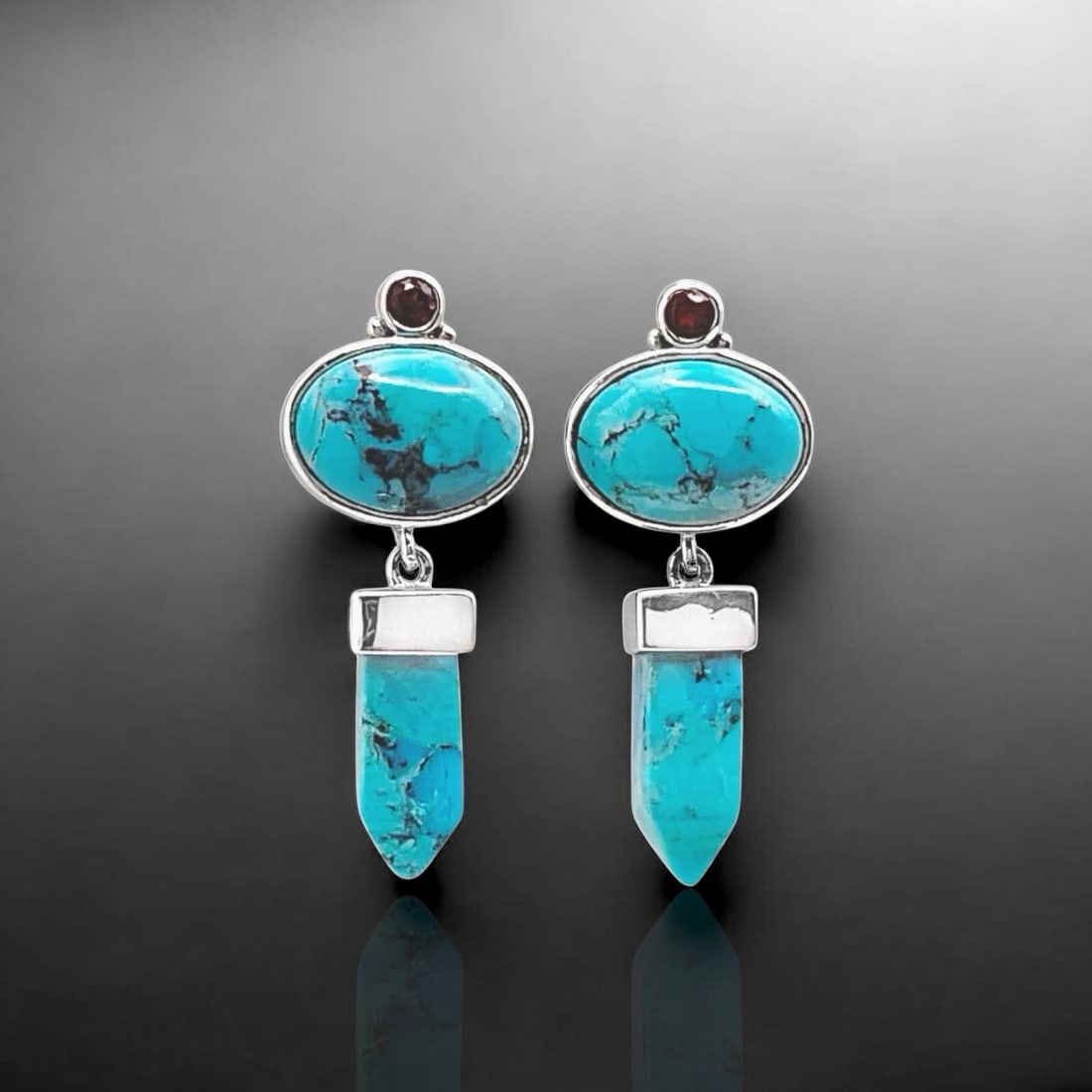 Turquoise Earrings Crafted in Sterling Silver with Garnet: Product Details Item: Earrings Metal: Sterling Silver Gemstone: Stabalized Turquoise & Garnet Approximate Measurements: 38.1 mm X 15.8 mm Ring Size: Not Applicable Chain Length: Not Applicable<