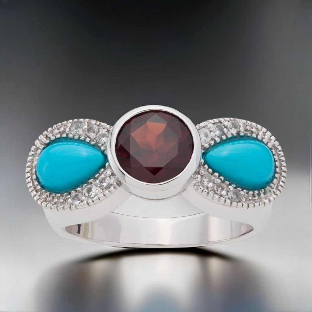 Sleeping Beauty Turquoise & Garnet Bow Ring with White Topaz Accents - Size 9: Stabilized Sleeping Beauty Turquoise: Two pear shaped 7 mm X 4.5 mm cabochons Garnet: One round modified-brilliant cut 7 mm White Topaz: 12 round modified-brilliant cut 1.25 mm Product Details Item: R