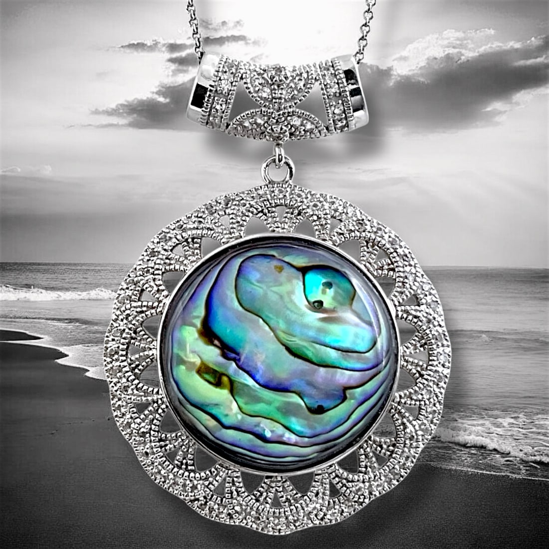 Bali Style Abalone Sterling Silver Pendant with 1.48 Cttw White Topaz Accents: 1.48 Cttw white topaz gems A total of 74 White Topaz 1.5 mm round accents Product Details Item: Pendant Metal: Sterling Silver Gemstone: Abalone/ (74)1.5 mm & White Topaz Approximate Measurements: 59.