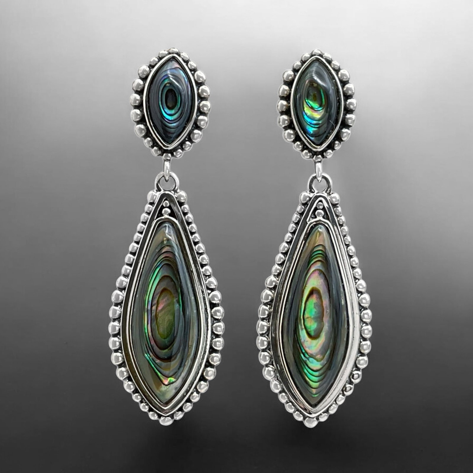Mesmerizing Abalone Drop Earrings crafted in Sterling Silver: Product Details Item: Earrings Metal: Sterling Silver Gemstone: Abalone Approximate Measurements: 53.3 mm X 16.5 mm Ring Size: Not Applicable Chain Length: Not Applicable Chain Metal: