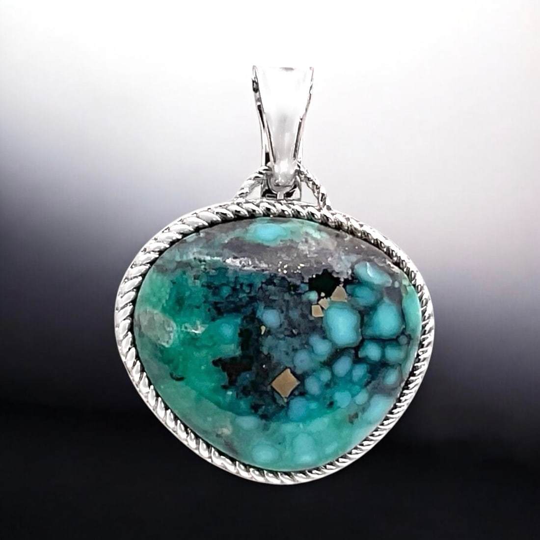Campo Frio Turquoise Freeform design Sterling Silver Pendant: Product Details Item: Pendant Metal: Sterling Silver Gemstone: Campo Frio Turquoise Approximate Measurements: 34.5 mm X 26 mm Ring Size: Not Applicable Chain Length: Not Applicable Chain