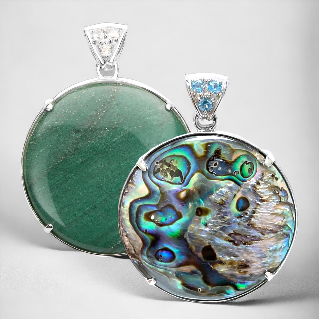 Elegant Reversible Sterling Silver Pendant with Green Adventurine on one side and Abalone on the: 40 mm Round Centerstones: Abalone & Green Adventurine Product Details Item: Pendant Metal: Sterling Silver Gemstone: Adventurine, Abalone, Swiss Blue Topaz, & White Topaz Approximate Measurements: 53.
