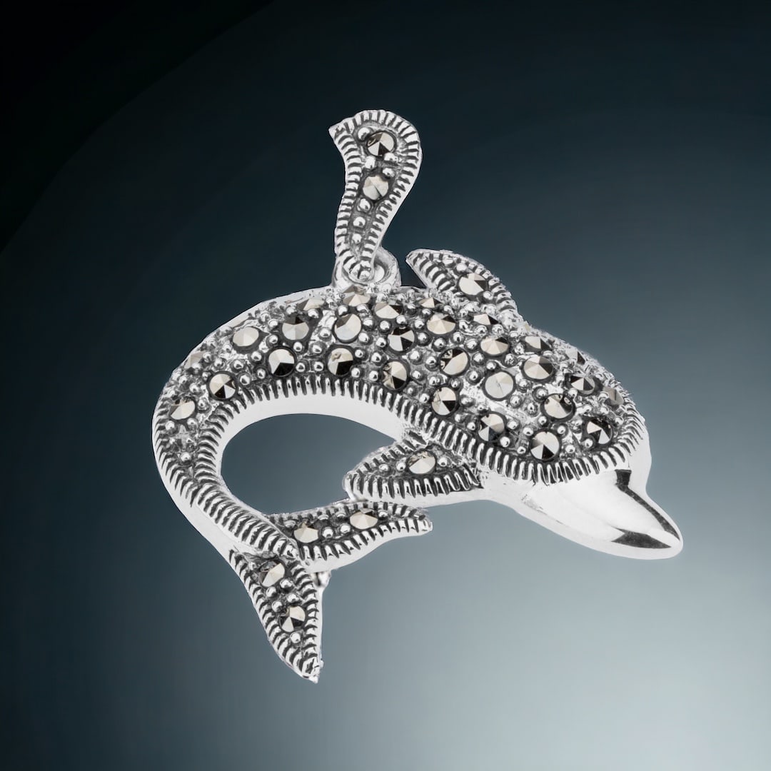 Dazzling Marcasite Dolphin Pendant set in Sterling Silver: Product Details Item: Pendant Metal: Sterling Silver Gemstone: Marcasite Approximate Measurements: 33.5 mm X 29.2 mm Ring Size: Not Applicable Chain Length: Not Applicable Chain Metal