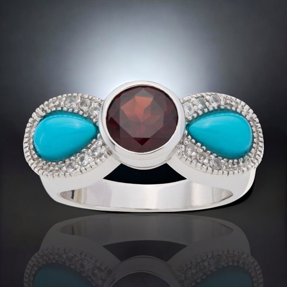 Sleeping Beauty Turquoise & Garnet Bow Ring with White Topaz accents - Size 8: Stabilized Sleeping Beauty Turquoise: Two pear shaped 7 mm X 4.5 mm cabochons Garnet: One round modified-brilliant cut 7 mm White Topaz: 12 round modified-brilliant cut 1.25 mm Product Details Item: R