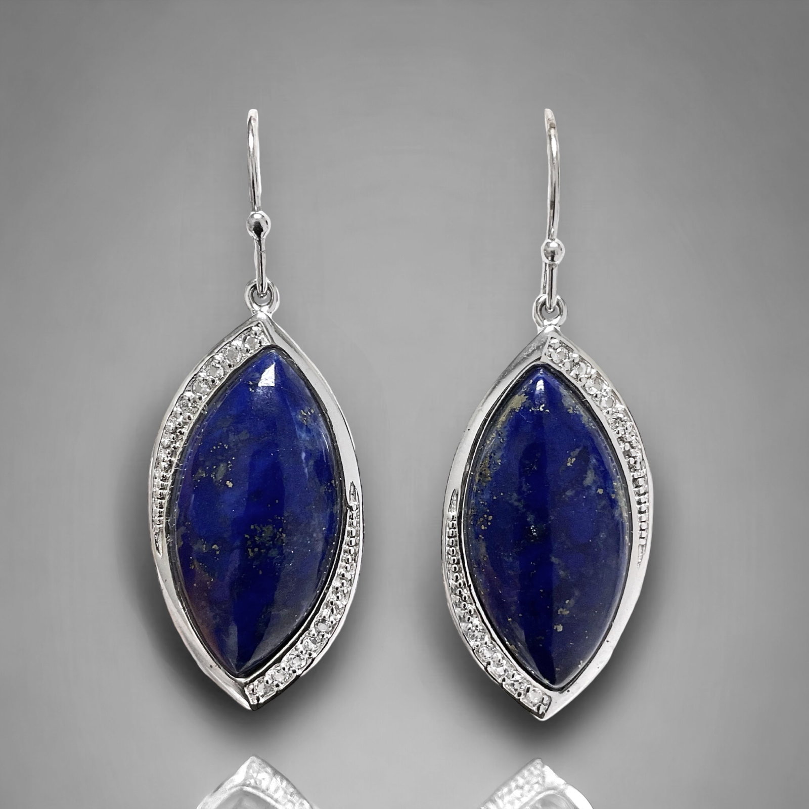 Deep Blue Lapis Earrings in Sterling Silver with White Topaz: Product Details Item: Earrings Metal: Sterling Silver Gemstone: Lapis & White Topaz Approximate Measurements: 45.4 mm X 16 mm Ring Size: Not Applicable Chain Length: Not Applicable Chain