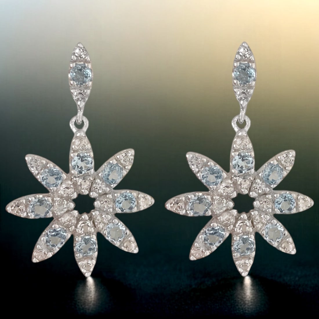 Dazzling Blue & White Topaz Starburst Earrings set in Sterling Silver: Product Details Item: Earrings Metal: Sterling Silver Gemstone: Blue Topaz & White Topaz Approximate Measurements: 33.6 mm X 19.7 mm Ring Size: Not Applicable Chain Length: Not Applicable