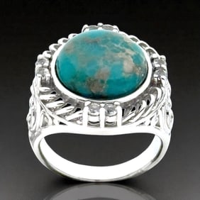 Campo Frio Turquoise cabochon is artfully crowned wtih mesmerizing spirals of sterling silver