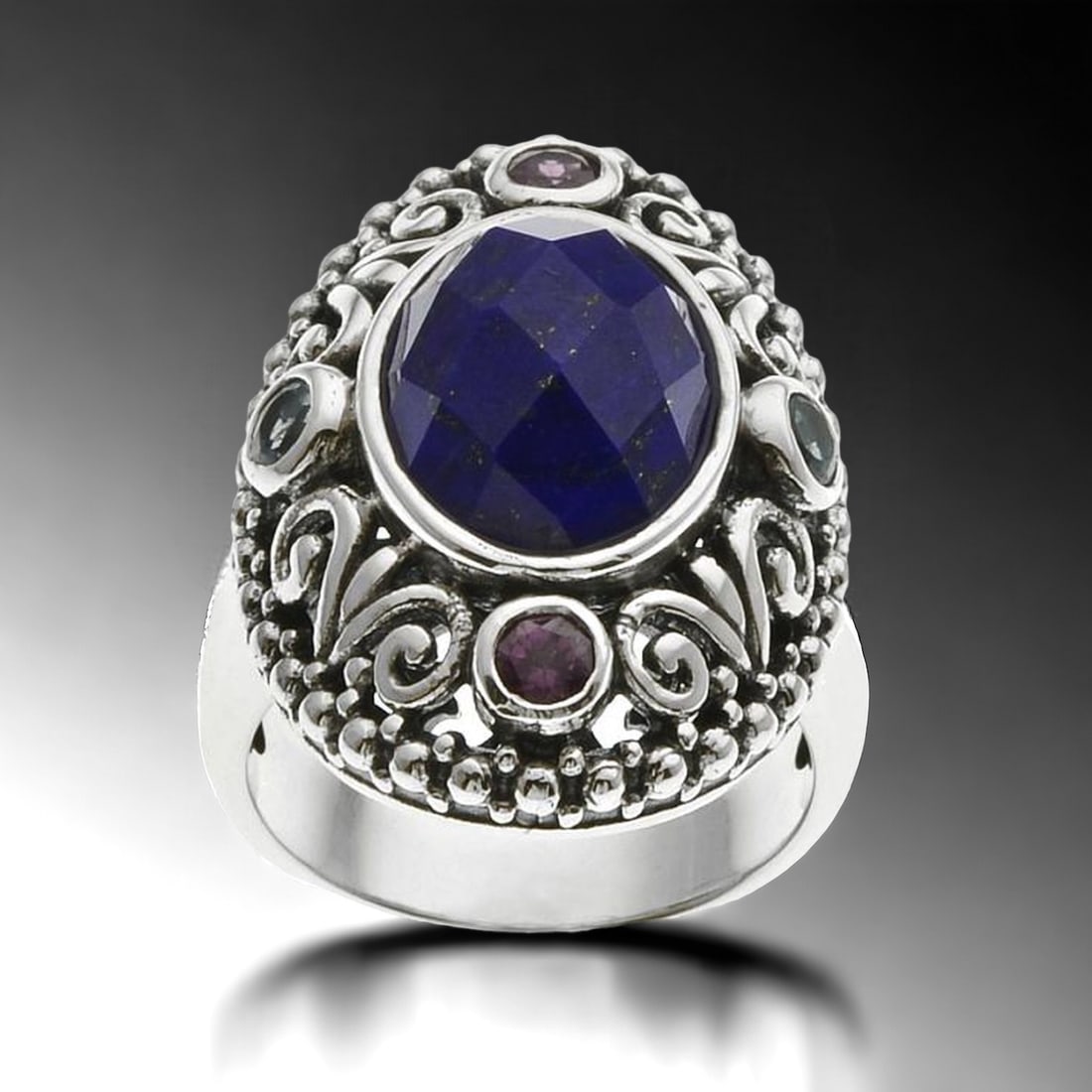 Bali design Lapis Lazuli Sterling Silver Ring with Swiss Blue Topaz & Rhodolite Garnet: Product Details Item: Ring Metal: Sterling Silver Gemstone: Lapis Lazuli, Swiss Blue Topaz, & Rhodolite Garnet Approximate Measurements: Width: 26.6 mm Ring Size: 6 Chain Length: Not Applicable
